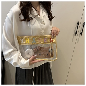 Transparent PVC clutch bag with colorful SNACKS letter embroidery and golden trim detail