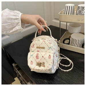 Detail of mini quilted backpack with cute bunny prints and elegant gold chain strap