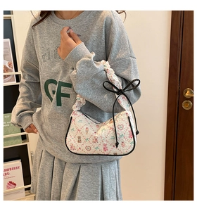 Shoulder bag detail featuring white textured fabric with cute bear and rabbit prints