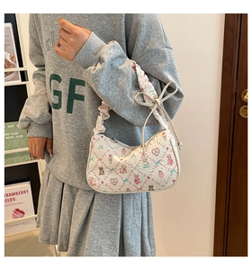 Detail of ruched handle and sweet cartoon bear print on white fashion handbag