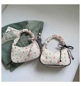 Detail of floral printed shoulder bags with ruffles and cute bow accents