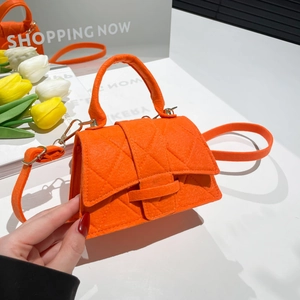 Bright orange quilted felt mini handbag with gold hardware and removable shoulder strap