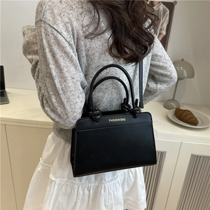 Women's black leather tote bag with unique knot handles and Fashion Bag logo