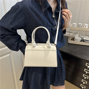 Chic cream tote bag with twisted handles and detachable strap for casual commuting