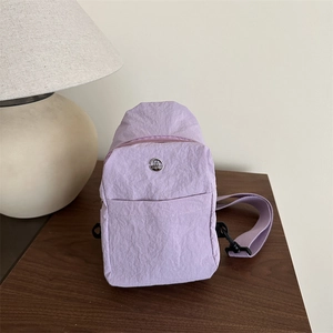 Light purple nylon outdoor chest bag with metal M logo and adjustable fabric strap