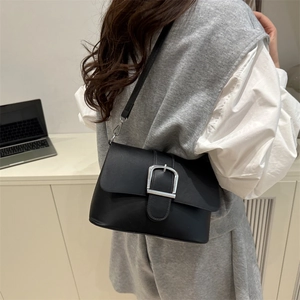 Minimalist matte black leather shoulder bag with large silver square metal buckle