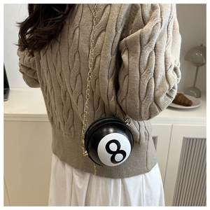 Detail of creative Billiard 8-Ball mini crossbody bag with gold chain on model