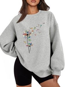 Detail of artistic dandelion and flying book print on gray crewneck fleece sweatshirt