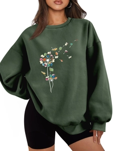 Detail of creative dandelion book print on forest green crewneck fleece sweatshirt
