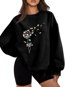 Detail of artistic colorful book dandelion print on a black long sleeve crewneck sweatshirt