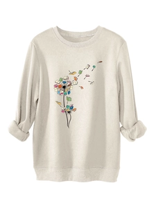 Detail view of dandelion book print on cozy beige fleece sweatshirt with ribbed cuffs