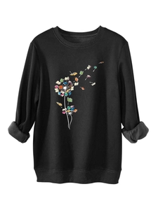Close-up of dandelion book print and thick warm fabric texture on black sweatshirt