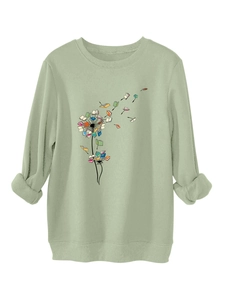 Detail of sage green sweatshirt showing thick fabric and creative book dandelion print