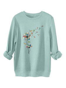 Detail of mint green sweatshirt featuring a creative colorful book dandelion print design