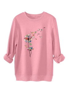 Detail of pink sweatshirt featuring creative dandelion book illustration and ribbed cuffs