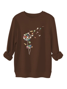 Detail of ribbed cuffs and creative dandelion book print on a brown fleece sweatshirt