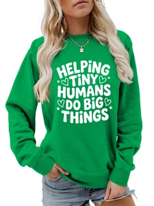 Detail of green crewneck sweatshirt with Helping Tiny Humans Do Big Things white print