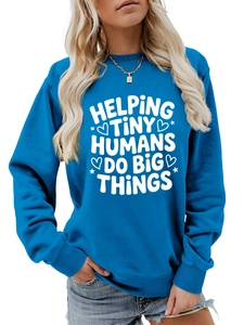 Close-up of royal blue sweatshirt featuring Helping Tiny Humans Do Big Things white text