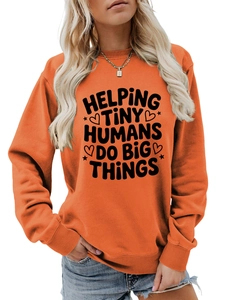 Detail of orange crewneck sweatshirt with Helping Tiny Humans print and ribbed cuffs