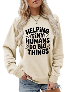 Close-up of Helping Tiny Humans text print on cream crewneck sweatshirt with ribbed cuffs