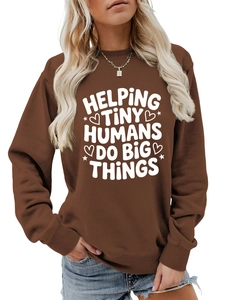 Close-up of a brown sweatshirt featuring the Helping Tiny Humans Do Big Things slogan