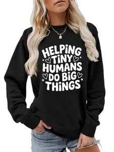 Close-up of Helping Tiny Humans Do Big Things slogan print on black crewneck sweatshirt