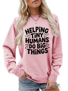 Pink crewneck sweatshirt with Helping Tiny Humans Do Big Things text and ribbed details