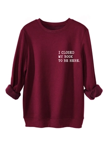Detail of the white lettering print on a burgundy casual thick fleece sweatshirt