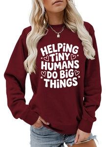 Detail of burgundy crewneck sweatshirt with white Helping Tiny Humans slogan print