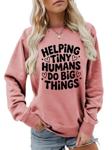 Detail of pink crewneck sweatshirt with Helping Tiny Humans Do Big Things print