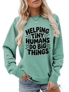 Detail of mint green crewneck sweatshirt with Helping Tiny Humans slogan print