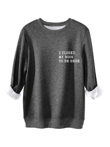 Close-up of charcoal gray sweatshirt with white fleece lining and chest slogan print