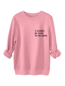 Close-up of I CLOSED MY BOOK print on a pink casual sweatshirt with ribbed cuffs