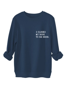 Detail of navy sweatshirt featuring white typewriter style slogan I CLOSED MY BOOK print