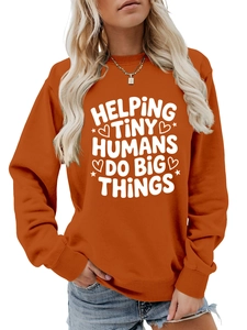Detail of soft orange sweatshirt with Helping Tiny Humans Do Big Things text and ribbed cuffs