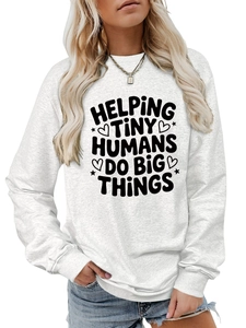 Close-up of Helping Tiny Humans Do Big Things slogan print on a white cotton sweatshirt