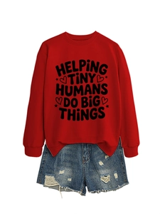 Detail of red crewneck sweatshirt with 'Helping Tiny Humans' text and ripped denim shorts