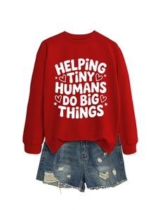 Close-up of red long sleeve sweatshirt with Helping Tiny Humans print and denim shorts