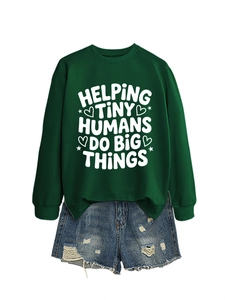 Flat lay of forest green sweatshirt with Helping Tiny Humans print and denim shorts