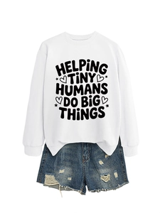 Detail of white sweatshirt with Helping Tiny Humans print and ripped denim shorts