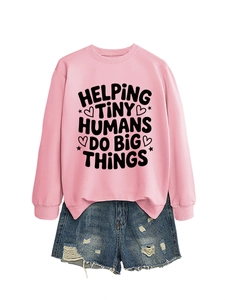 Detail of pink sweatshirt with helping tiny humans quote and distressed denim shorts