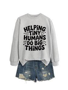 Detail showing 'HELPING TINY HUMANS' slogan print on a grey casual sweatshirt