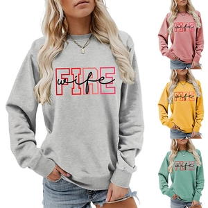 Detail showing various colors of the FIRE wife crewneck sweatshirt and gray fabric texture