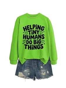 Flat lay of neon green sweatshirt with 'Helping Tiny Humans' text and denim shorts