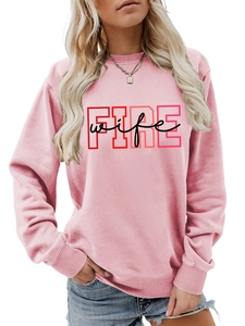 Detailed view of pink crewneck sweatshirt with FIRE wife lettering and ribbed cuffs