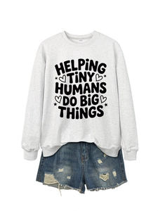 Flat lay of white crewneck sweatshirt with Helping Tiny Humans print and denim shorts