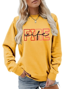 Detail of ginger yellow crewneck sweatshirt with ribbed cuffs and Fire Wife print