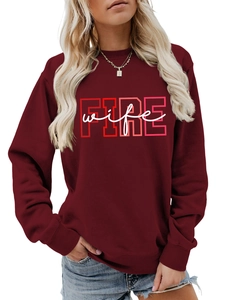 Close-up of burgundy crewneck sweatshirt featuring red FIRE and white wife lettering