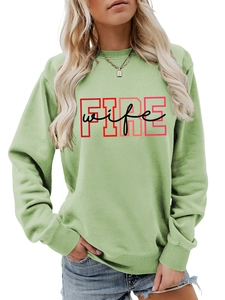 Detail of the light green sweatshirt featuring FIRE wife printed graphic and ribbed cuffs
