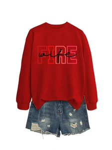 Detail of red crewneck sweatshirt with FIRE wife print and distressed denim shorts